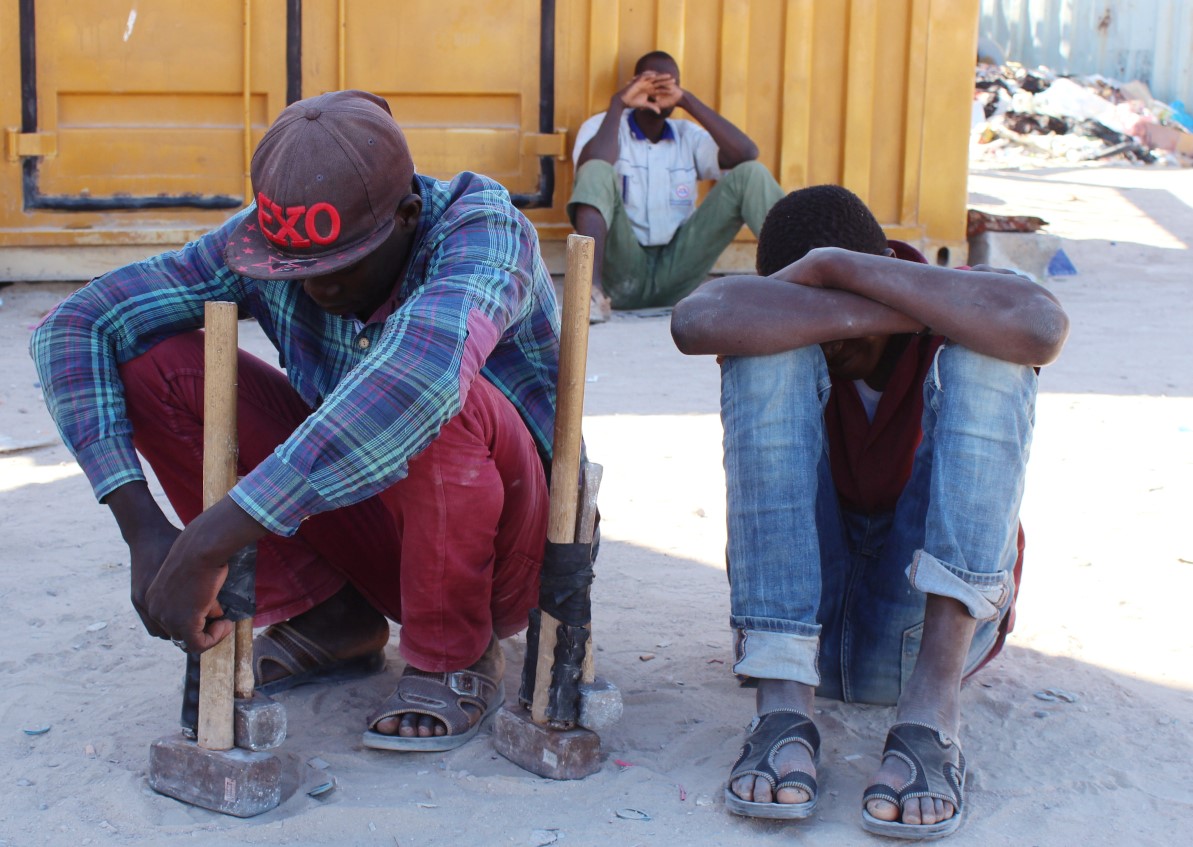 Migrants sit on the side of a road as they wait for work, following the outbreak of Covid-19, Misrata, Libya, 2 May 2020. Reuters, Ayman Al-Sahili.