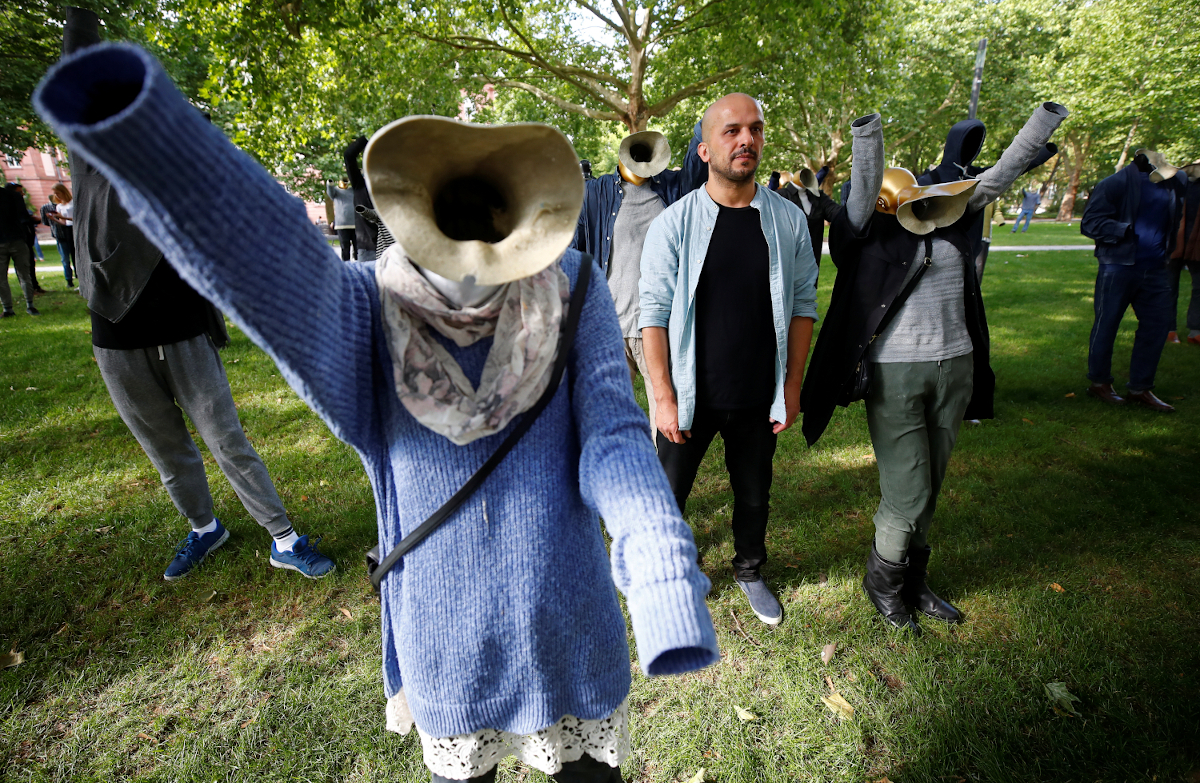 Syrian artist Khaled Barakeh stands amid his installation "The Muted Demonstration" outside a Koblenz court during the first trial against suspected members of Syrian President Bashar al-Assad's security services for crimes against humanity, Koblenz, Germany, 1 July 2020. Reuters, Wolfgang Rattay.