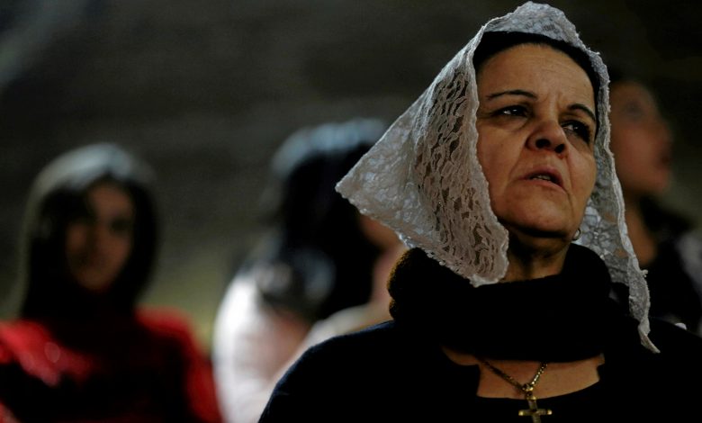 An Egyptian Christian woman attends Coptic Christmas eve mass in a church of the Samaan el-Kharaz Monastery in the Mokattam Mountain area, Cairo, Egypt, 6 January 2017. Reuters, Amr Abdallah Dalsh.