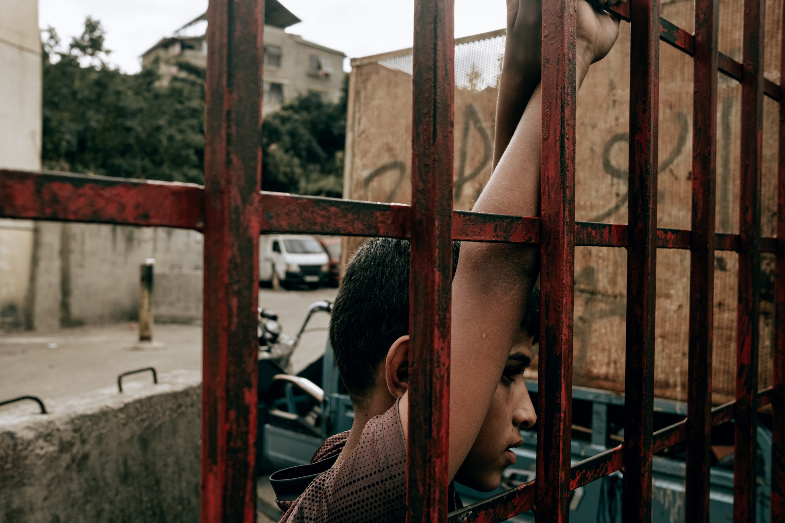 صبي يشاهد مباراة لكرة القدم من خلف قضبان، شاتيلا، بيروت، لبنان، 11 أكتوبر 2020. كارين بيير، وكالة هانز لوكاس، عبر رويترز.