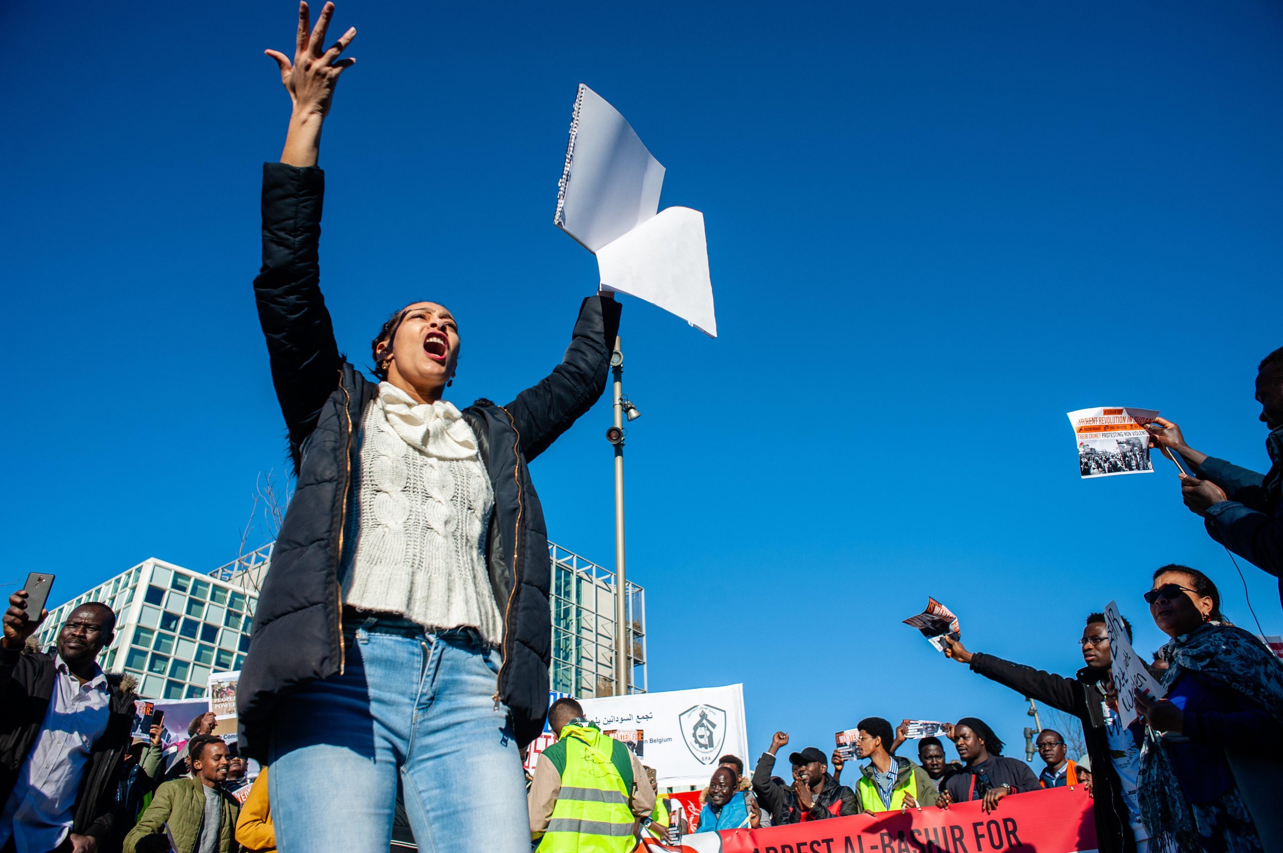 Protestors chanting during a demonstration outside the International Criminal Court in the Hague in solidarity with the revolution in Sudan, 15 February 2019. Source: ZUMA Press/ Alamy via Reuters.