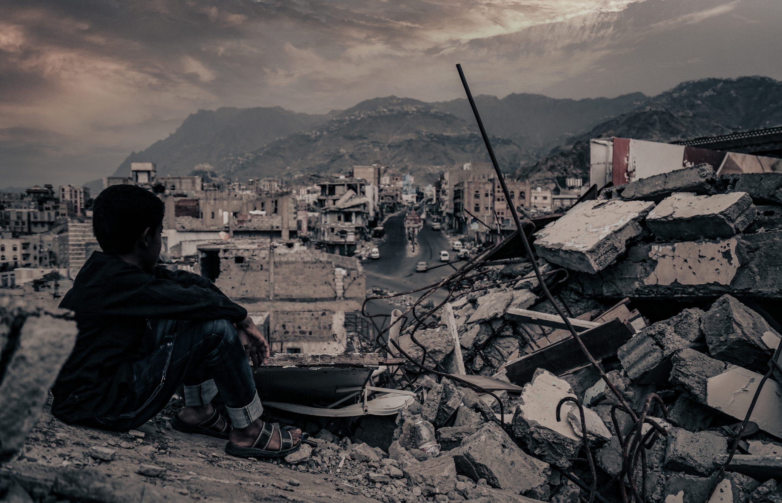 A child from Taiz City sits on the ruins of his home caused by the war in Yemen, 22 August 2016. Source: Shutterstock via Akram Alrasny.