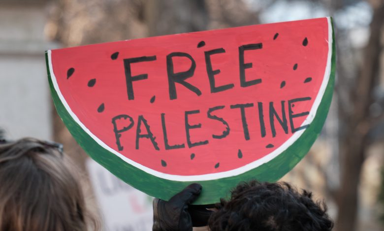 A photo of a protest sign in the shape of a watermelon at a Free Palestine rally in Halifax, Canada, 9 December 2023. Source: Wandering Views via Shutterstock.