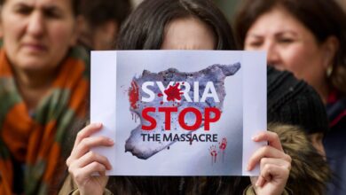 Image of a slogan displayed during a protest in Frankfurt, Germany, against the massacre of Alawites in Syria, 15 March 2025. Source: Ryan Nash Photography via Shutterstock.