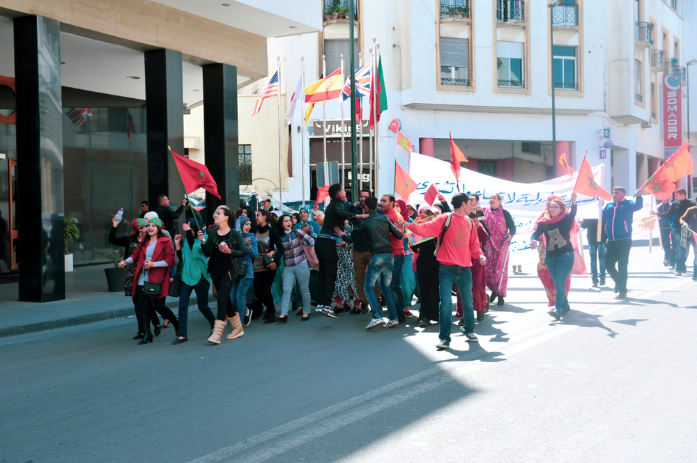 An image of Moroccan youth protesting in Rabat while carrying Moroccan flags, 7 December 2019. Source: Africa Stock via Shutterstock.